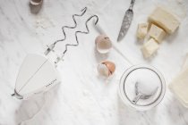 Top view of baking ingredients with a hand mixer, sugar and butter — Stock Photo