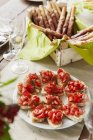 Bruschetta with tomatoes and grissini with Parma ham — Stock Photo