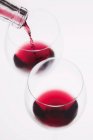 Red wine poured into glass — Stock Photo