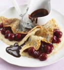 Pancakes with cherries and chocolate — Stock Photo