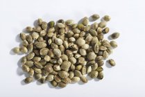 Hemp seeds against white — Stock Photo