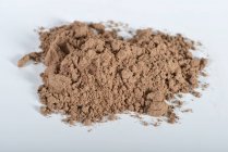 Closeup view of red clay heap on a white surface — Stock Photo