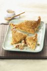 Puff pastry turnovers with sauerkraut filling on blue plate over mat — Stock Photo
