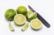 Fresh limes and knife — Stock Photo
