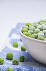Frozen green peas in bowl — Stock Photo
