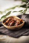 Dried tomatoes in wooden bowl — Stock Photo