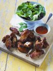 Spicy chicken wings with chili sauce — Stock Photo