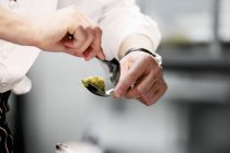 Chef shaping quenell in kitchen — Stock Photo
