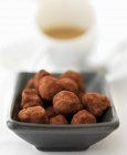 Chocolate truffles with coffee — Stock Photo