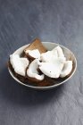 Pieces of fresh coconut in bowl — Stock Photo