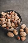 Mixed nuts in metal bowl — Stock Photo