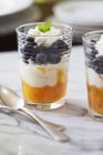 Closeup view of two glasses of blueberry and mango parfait — Stock Photo