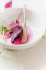 Half a beetroot in a bowl with knife — Stock Photo