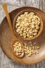 Pine nuts in wooden bowl — Stock Photo
