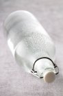 Closeup view of one wet water bottle on side — Stock Photo
