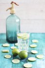 Glass of water with lime slices — Stock Photo