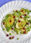 Broad beans and pomegranate seeds — Stock Photo