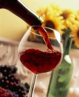 Red wine being poured into glass — Stock Photo