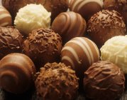 Chocolate truffles in row — Stock Photo