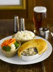 Chicken and mushroom pie with vegetables and mashed potatoes in a pub — Stock Photo