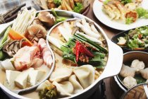 Chinese hotpot on wooden surface — Stock Photo