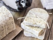 Closeup view of homemade white soap with oats — Stock Photo