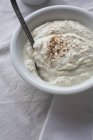 Closeup view of cinnamon quark in bowl with spoon — Stock Photo