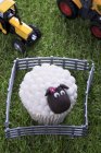 Easter lamb cupcake and toy tractors — Stock Photo