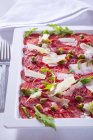 Carpaccio slices of raw beef — Stock Photo