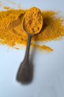 Turmeric powder on spoon — Stock Photo