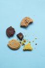 Broken biscuits on blue — Stock Photo