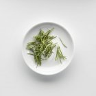 Plate of dried rosemary — Stock Photo