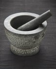 Closeup view of a one stone mortar with a pestle — Stock Photo