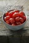 Bowl of mini plum tomatoes — Stock Photo