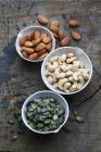 Bowls of almonds and seeds — Stock Photo