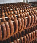 Sausages hanging on metal rack — Stock Photo