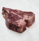 Fresh raw beef steak with salt — Stock Photo