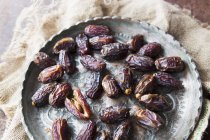 Dried dates on metal plate — Stock Photo