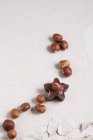Pralines with hazelnuts on white — Stock Photo