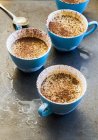 Closeup view of frozen Sabayon with cocoa powder in blue cups — Stock Photo
