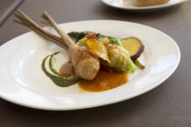 Pork belly and mashed potato roll with a cabbage leaf wrap on a stick of lemongrass served with pumpkin, asparagus, spinach and sweet potatoes — Stock Photo