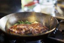 Fried beef steak in frying pan — Stock Photo