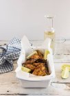 Smoked chicken wings with lime wedges — Stock Photo