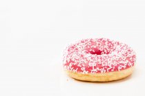 Pink doughnut with sugar sprinkles — Stock Photo