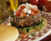 Greek burger with black olives — Stock Photo