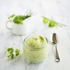 Closeup view of an open jar of vegan herbal cream — Stock Photo