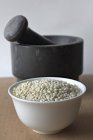 Sorghum grains in porcelain bowl — Stock Photo