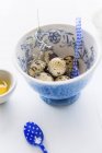 Quail eggs in floral patterned bowl — Stock Photo