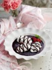 Closeup view of white dumplings in a berry soup with chocolate sauce — Stock Photo