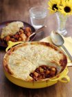 Bean pie in a pie dish  over wooden surface — Stock Photo